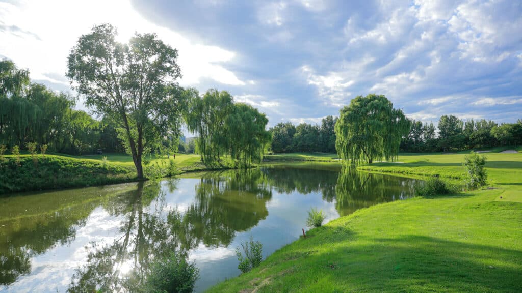 Lake and fairway of the golf course venue for the WCGC World Final 2026